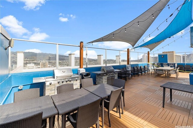 2427 Kuhio Ave Unit 906, Honolulu, HI 96815 - view of patio with outdoor dining space, area for grilling, and a mountain view