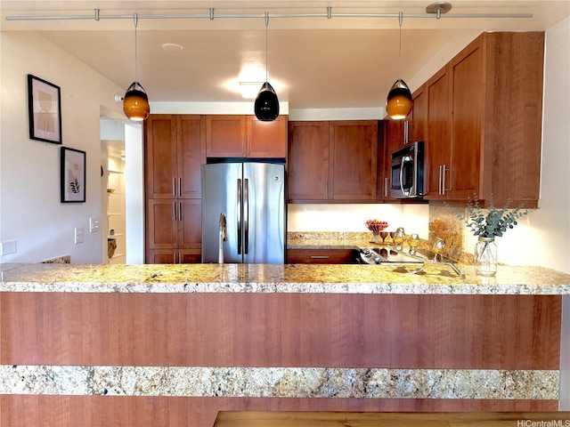555 Hahaione St Unit 10F, Honolulu, HI 96825 - kitchen with a peninsula, brown cabinetry, light stone countertops, and appliances with stainless steel finishes