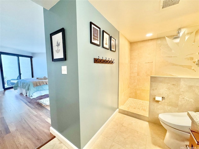 555 Hahaione St Unit 10F, Honolulu, HI 96825 - bathroom featuring toilet, baseboards, visible vents, walk in shower, and ensuite bath