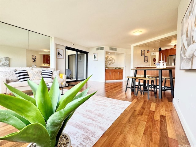 555 Hahaione St Unit 10F, Honolulu, HI 96825 - living area featuring wood finished floors, visible vents, and baseboards