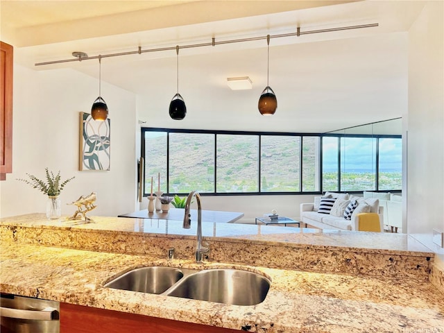 555 Hahaione St Unit 10F, Honolulu, HI 96825 - kitchen with dishwasher, a healthy amount of sunlight, light stone counters, and a sink