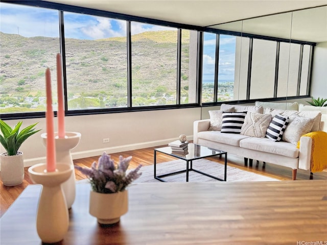 555 Hahaione St Unit 10F, Honolulu, HI 96825 - living room with wood finished floors, baseboards, and a wealth of natural light