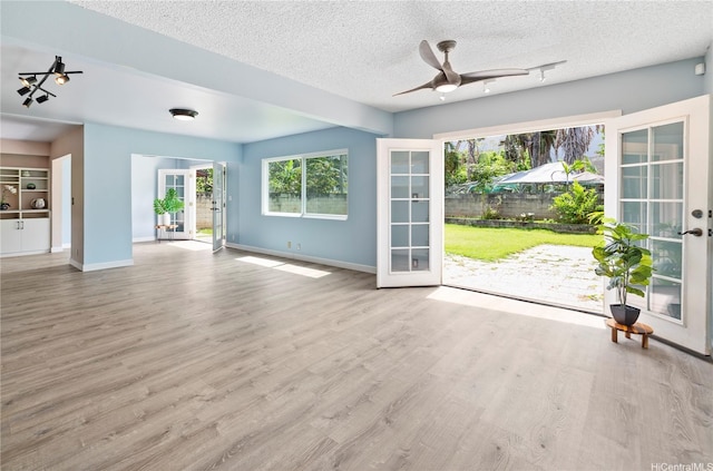 47-784 Kamehameha Hwy, Kaneohe, HI 96744 - unfurnished living room with a ceiling fan, baseboards, french doors, and wood finished floors