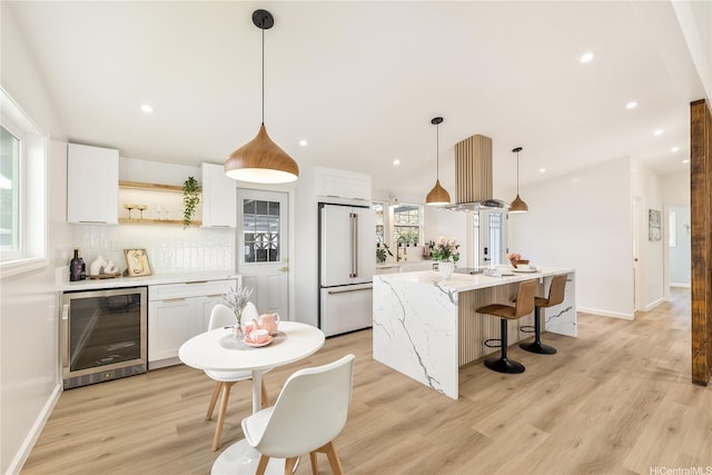 kitchen featuring white cabinets, wine cooler, open shelves, high end white refrigerator, and light wood-style flooring