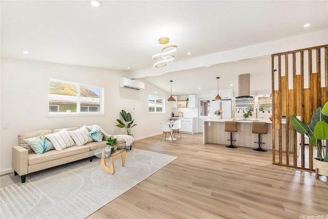 living room featuring an AC wall unit, vaulted ceiling, light wood-type flooring, baseboards, and recessed lighting