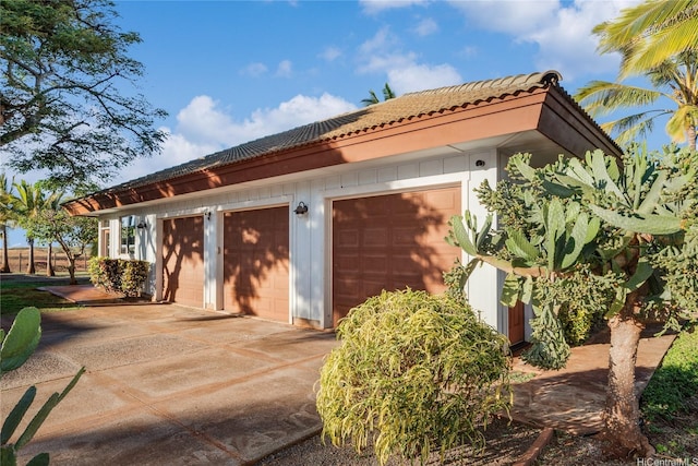 view of side of property featuring a tiled roof
