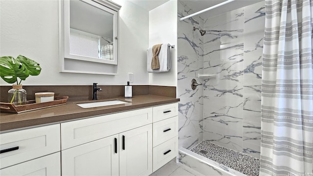 bathroom featuring marble finish floor, vanity, and a shower with curtain