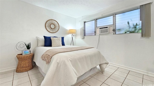 tiled bedroom featuring cooling unit and baseboards