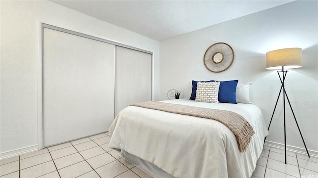 bedroom featuring a closet and light tile patterned floors
