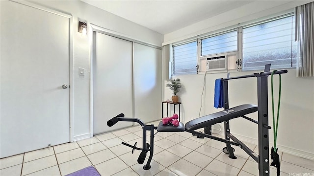 workout room featuring baseboards, tile patterned floors, and cooling unit