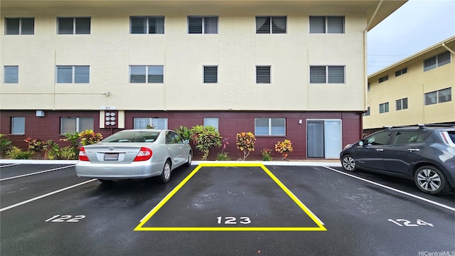 view of building exterior featuring uncovered parking
