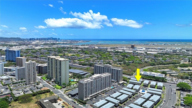 drone / aerial view featuring a city view and a water view