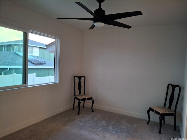unfurnished room featuring light carpet, a ceiling fan, and baseboards