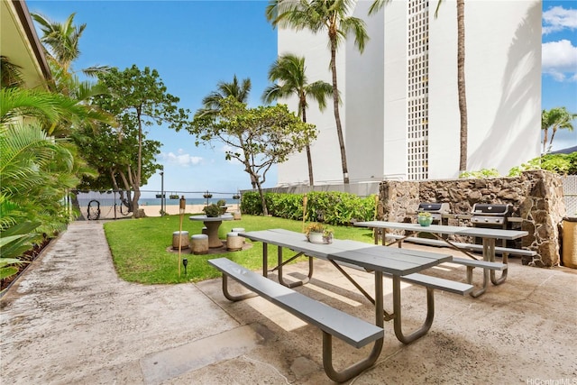 view of community featuring a yard and a patio