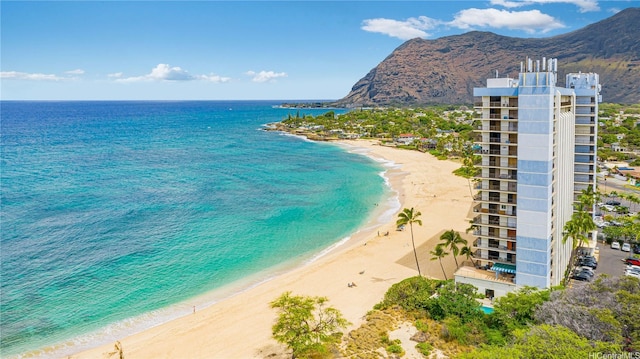 water view with a beach view and a mountain view