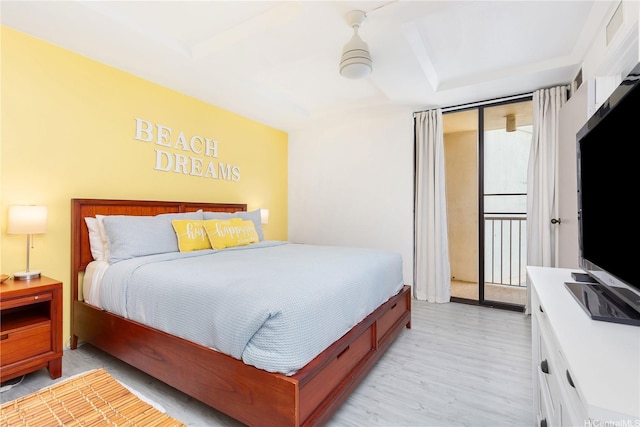 bedroom featuring access to outside, light wood-style floors, and visible vents