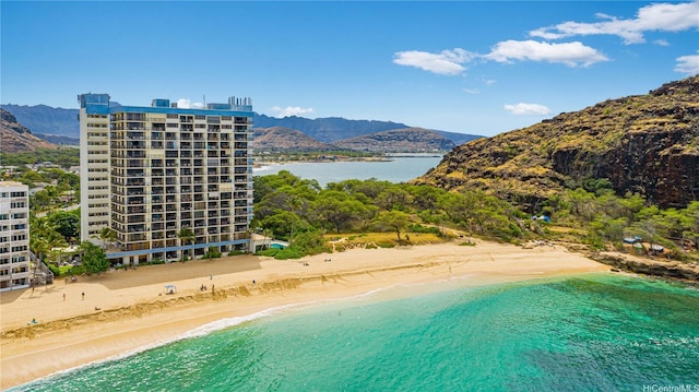 view of swimming pool featuring a beach view and a water and mountain view