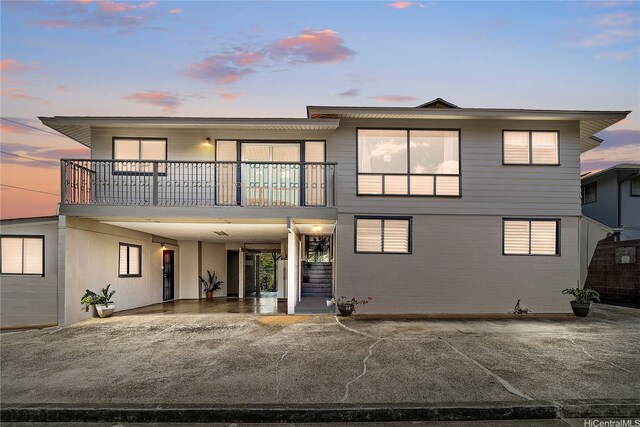 1727 Ema Pl, Honolulu, HI 96819 - back of property at dusk featuring a carport and a balcony