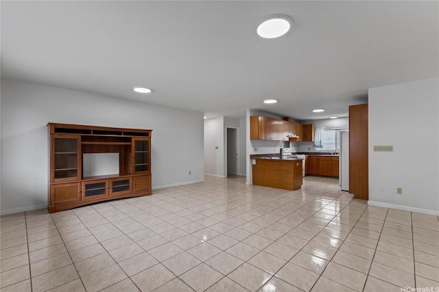 unfurnished living room featuring light tile patterned floors, baseboards, and recessed lighting