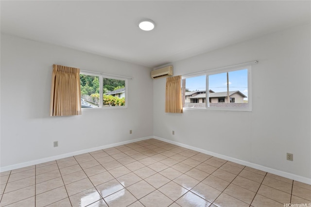 empty room featuring baseboards and a wall mounted air conditioner
