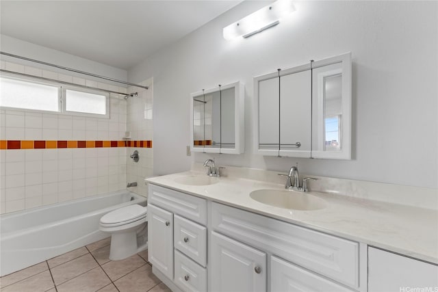 full bathroom with toilet, tub / shower combination, a sink, and tile patterned flooring