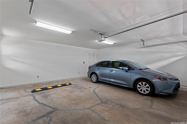 garage featuring baseboards and a garage door opener