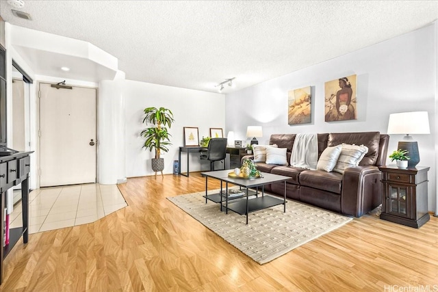1212 Nuuanu Ave Unit 1306, Honolulu, HI 96817 - living area featuring light wood-type flooring and a textured ceiling