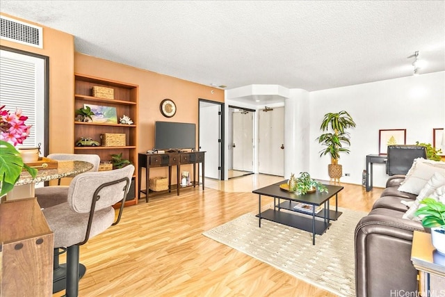 1212 Nuuanu Ave Unit 1306, Honolulu, HI 96817 - living area with a textured ceiling, wood finished floors, and built in features