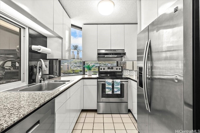 1212 Nuuanu Ave Unit 1306, Honolulu, HI 96817 - kitchen featuring stainless steel appliances, under cabinet range hood, a sink, light tile patterned flooring, and white cabinetry