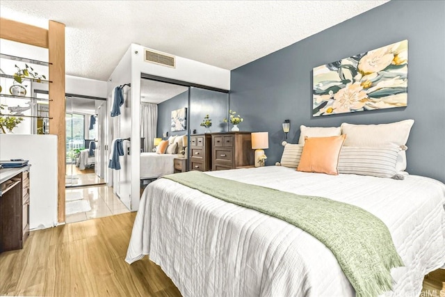1212 Nuuanu Ave Unit 1306, Honolulu, HI 96817 - bedroom featuring wood finished floors, a textured ceiling, and a closet