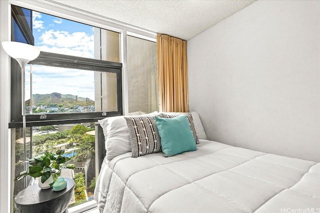 1212 Nuuanu Ave Unit 1306, Honolulu, HI 96817 - bedroom featuring multiple windows, a wall of windows, and a textured ceiling