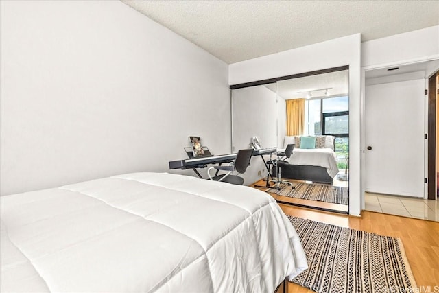 1212 Nuuanu Ave Unit 1306, Honolulu, HI 96817 - bedroom featuring wood finished floors and a textured ceiling