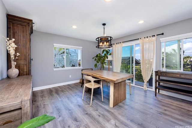dining room featuring wood finished floors, baseboards, recessed lighting, and a chandelier