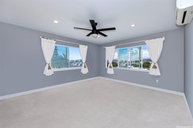 empty room featuring baseboards, carpet, recessed lighting, a wall mounted air conditioner, and a ceiling fan