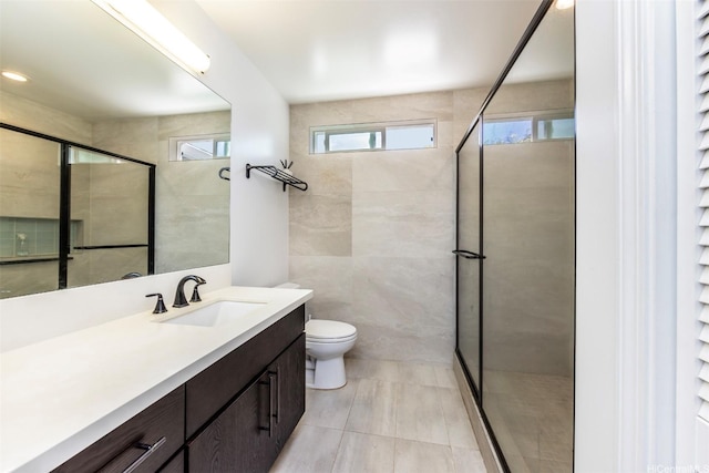 bathroom featuring a stall shower, vanity, and toilet