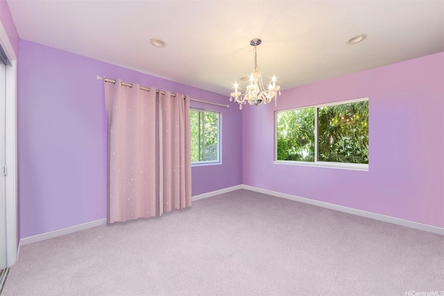 empty room featuring recessed lighting, an inviting chandelier, carpet floors, and baseboards
