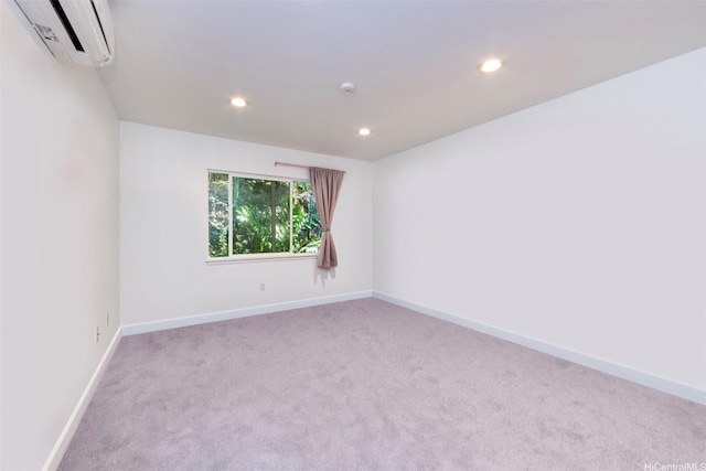 unfurnished room with baseboards, an AC wall unit, carpet, and recessed lighting