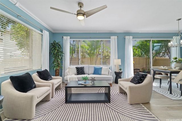 sunroom / solarium featuring plenty of natural light and a chandelier