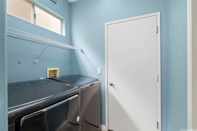 clothes washing area featuring separate washer and dryer