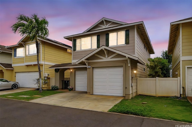 view of front of home with an attached garage, fence, and concrete driveway