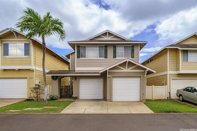 townhome / multi-family property with a garage, driveway, and fence
