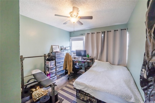 bedroom with a textured ceiling and ceiling fan