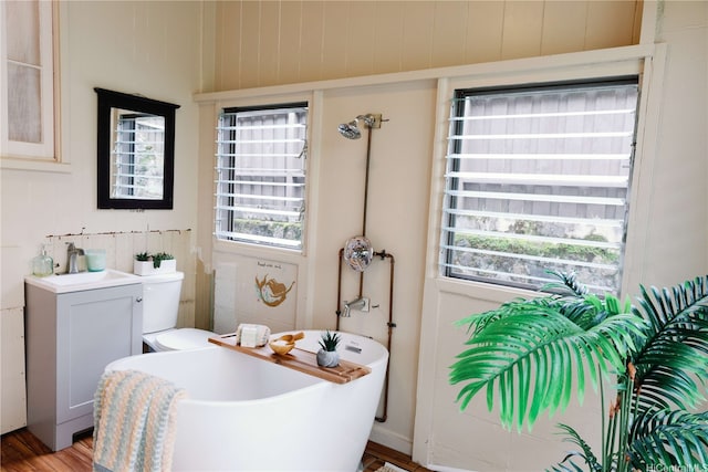 full bath with a soaking tub and a sink