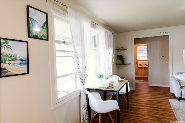dining space featuring baseboards and wood finished floors
