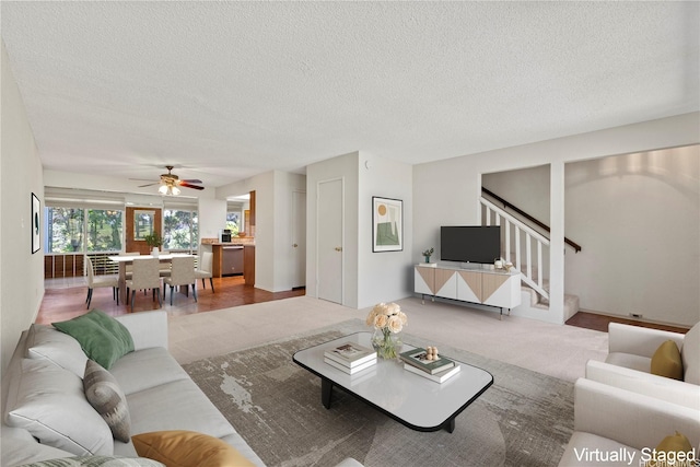98-1724 Kaahumanu St Unit 16C, Pearl City, HI 96782 - living area featuring ceiling fan, a textured ceiling, and stairs