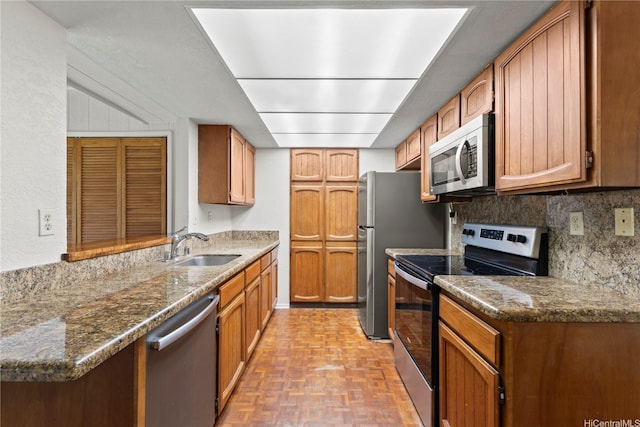 98-1724 Kaahumanu St Unit 16C, Pearl City, HI 96782 - kitchen featuring brown cabinetry, stainless steel appliances, tasteful backsplash, and a sink