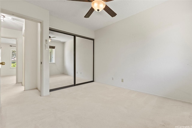 98-1724 Kaahumanu St Unit 16C, Pearl City, HI 96782 - unfurnished bedroom with a closet, light carpet, and ceiling fan