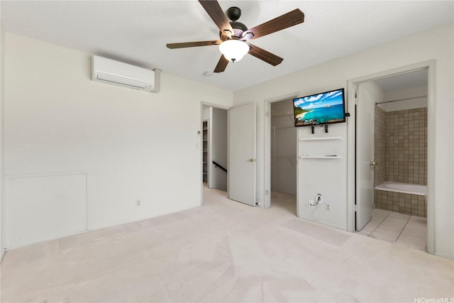 98-1724 Kaahumanu St Unit 16C, Pearl City, HI 96782 - unfurnished bedroom featuring a closet, a spacious closet, an AC wall unit, carpet floors, and connected bathroom