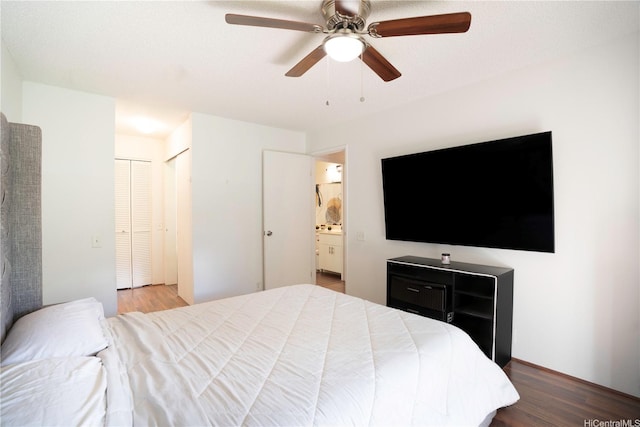 bedroom featuring wood finished floors, a ceiling fan, and connected bathroom