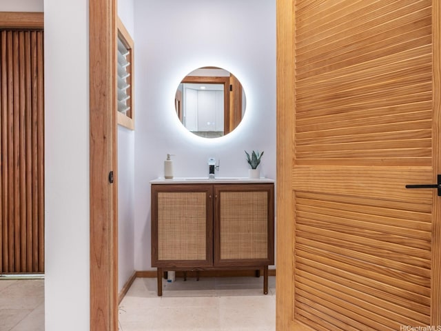 bathroom featuring baseboards, tile patterned floors, and vanity